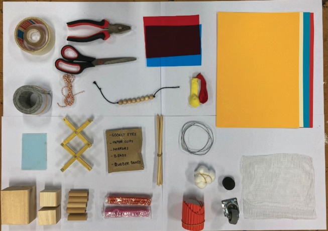 The full set of Multi Material Making toolkit materials laid out: wooden blocks, paper, fabric, magnets, wire, tape, scissors and more